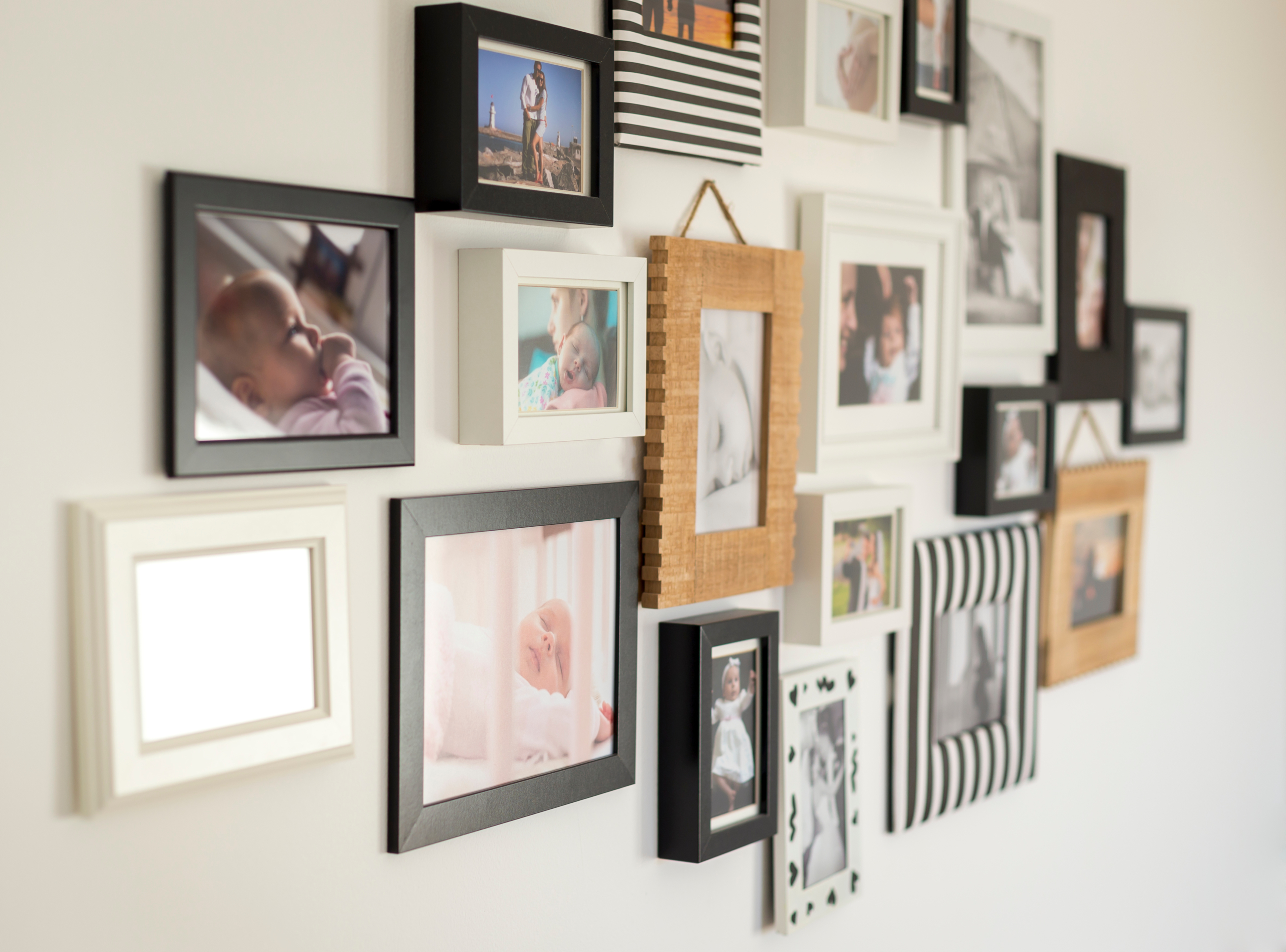 Family photo gallery with various picture frames on the wall