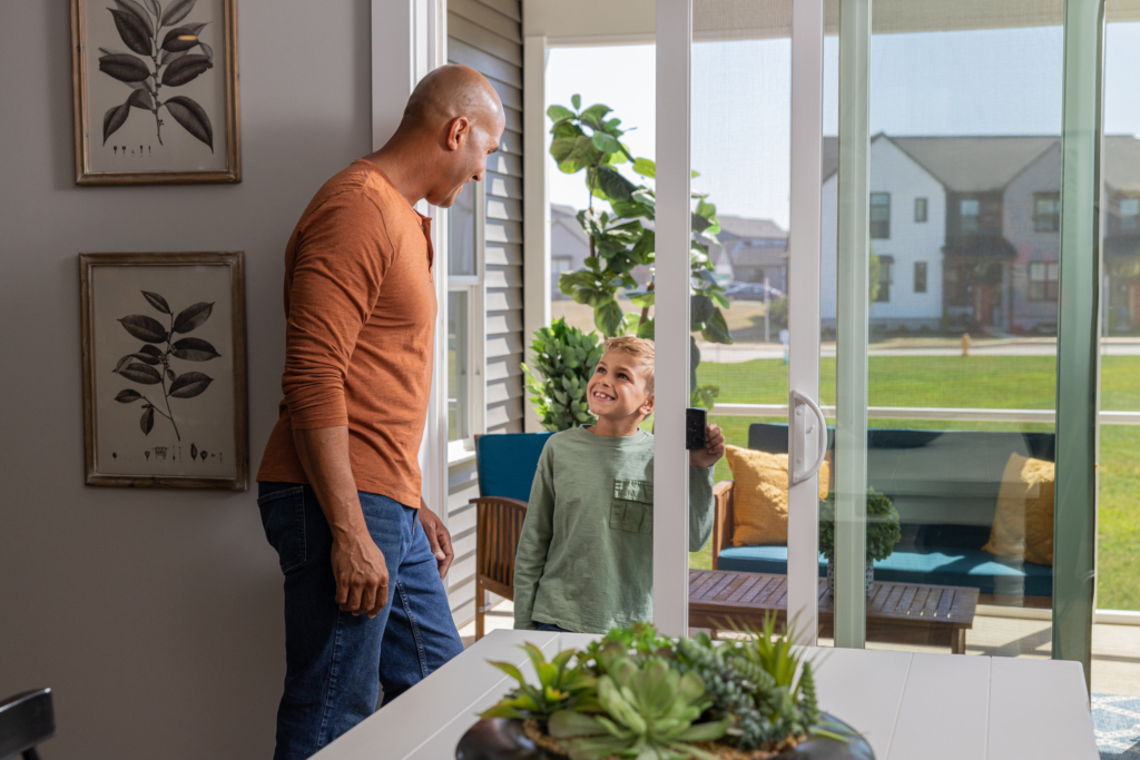 Father and son installing a new patio screen door for Mother's Day